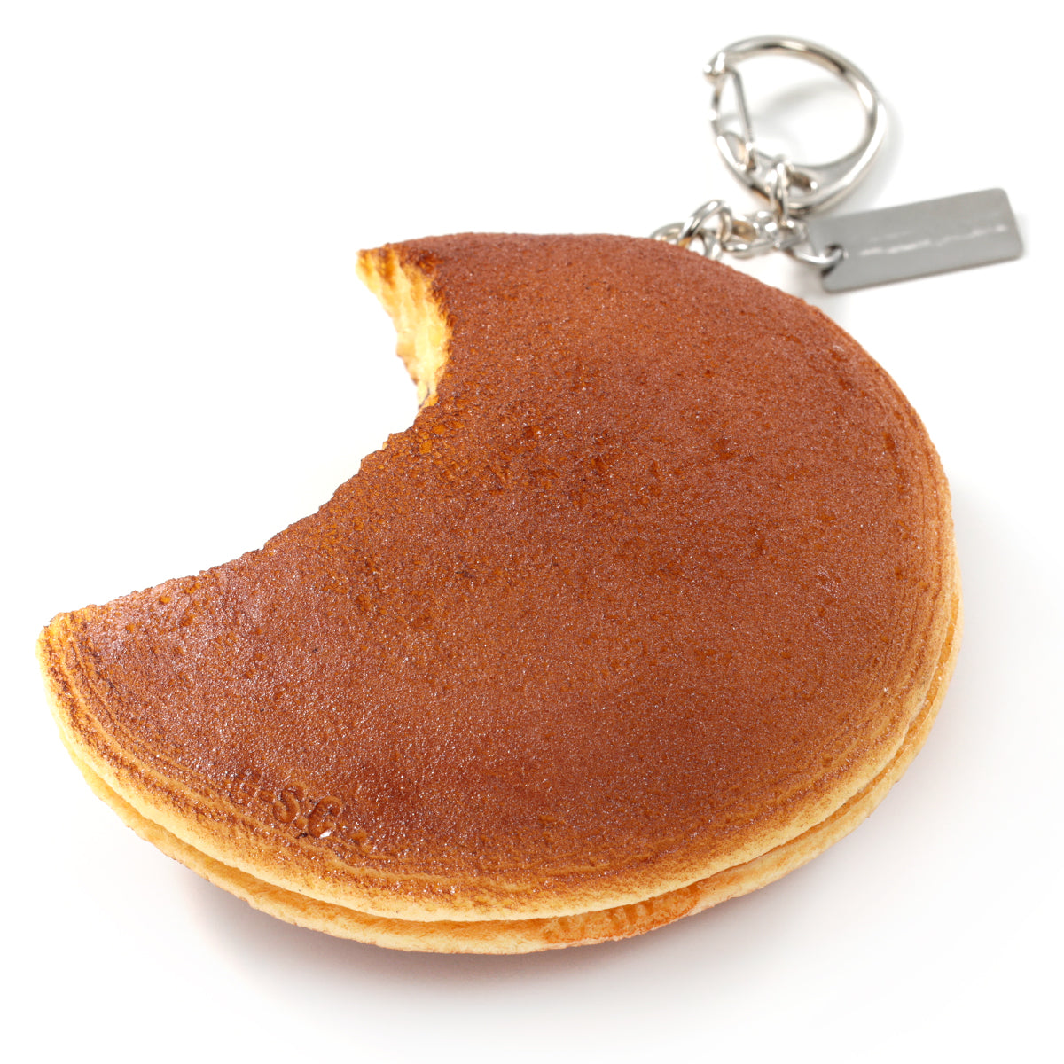 これは元祖食品サンプル屋の「キーリング かじったどら焼き」の商品裏面画像です。